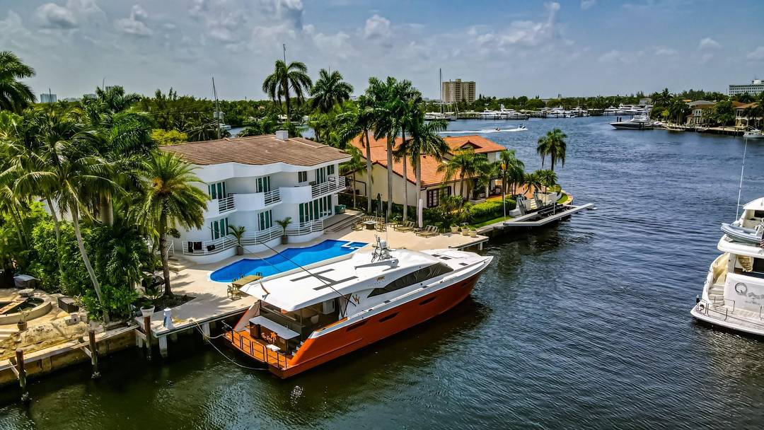 Reimagined Modern Deco Waterfront Estate located one from the point in prestigious Sunrise Key.