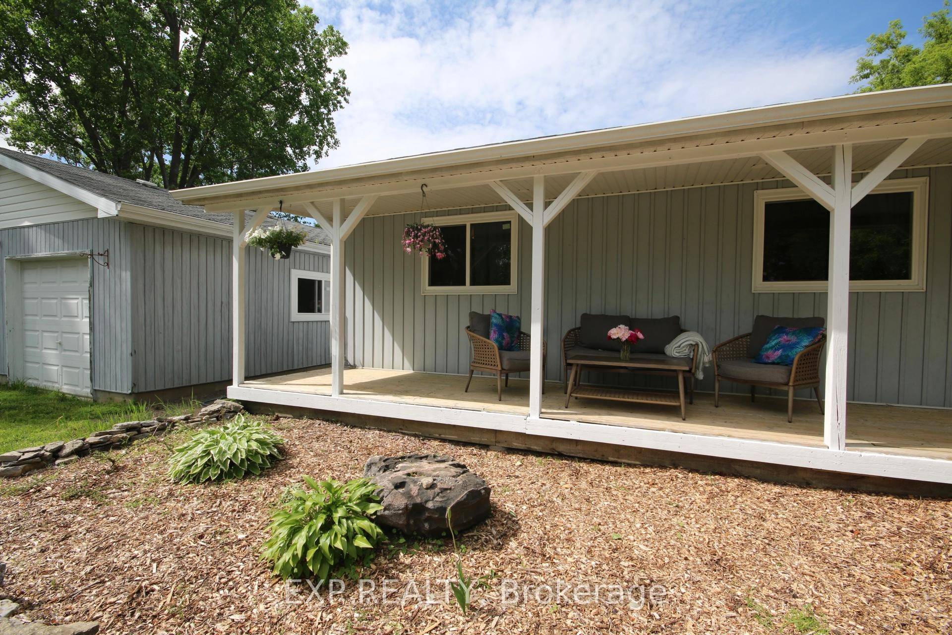 Country living just a few minutes from town, with a sunny yard and huge garage !