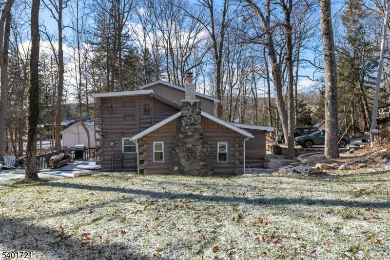 Are you looking for a new home with a babbling brook bordering the property, seasonal water views, has the charm of a log cabin ?