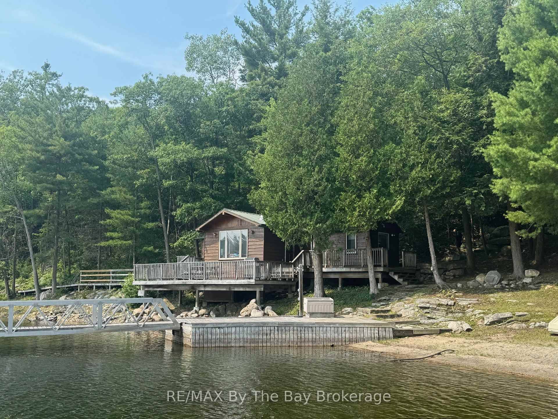 Discover this well loved family cottage on the pristine north shore of 12 Mile Bay with direct access to the magic of Georgian Bay.