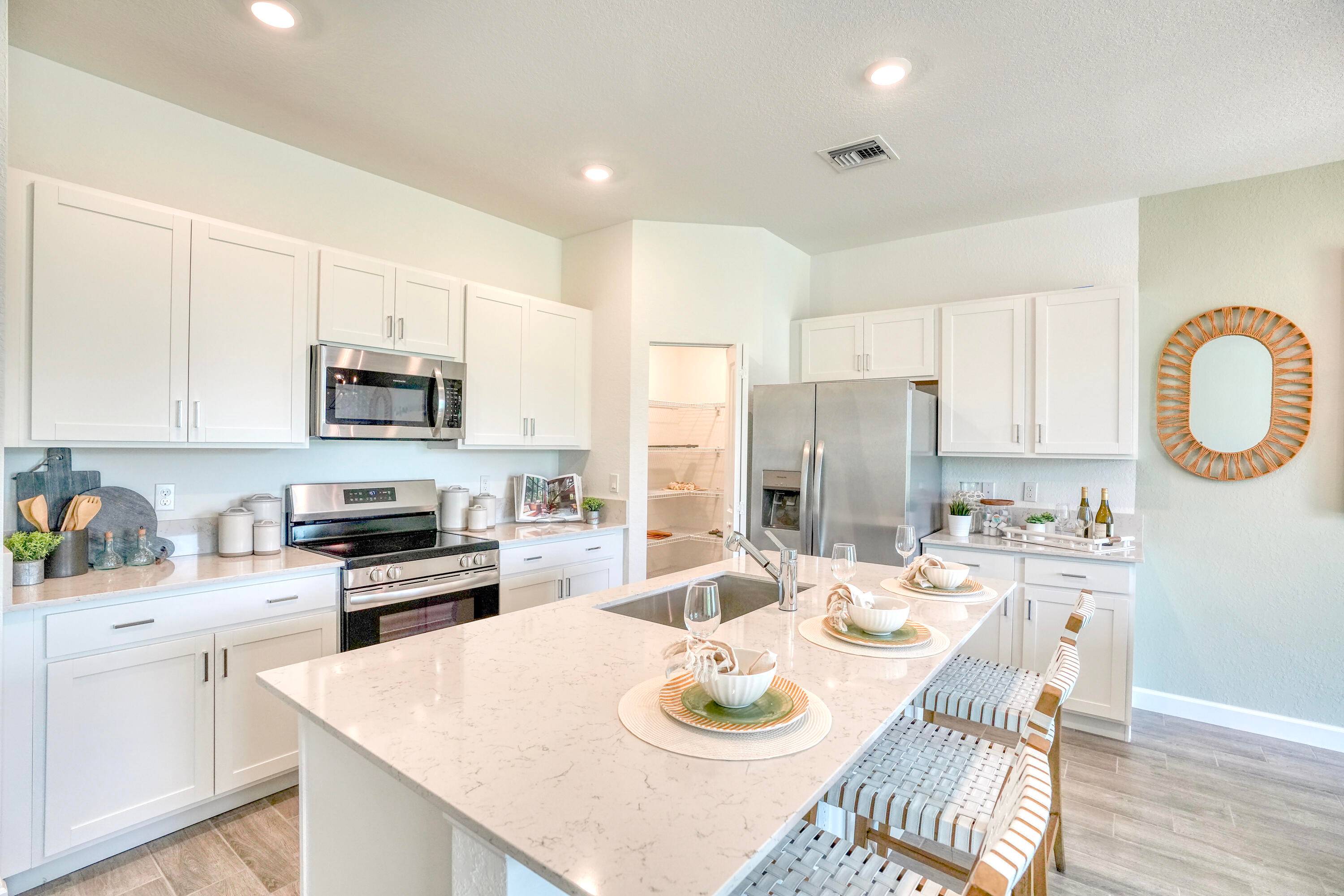 A two level townhome with an open concept kitchen, dining room and Great Room that shares the first floor along with a rear covered patio.