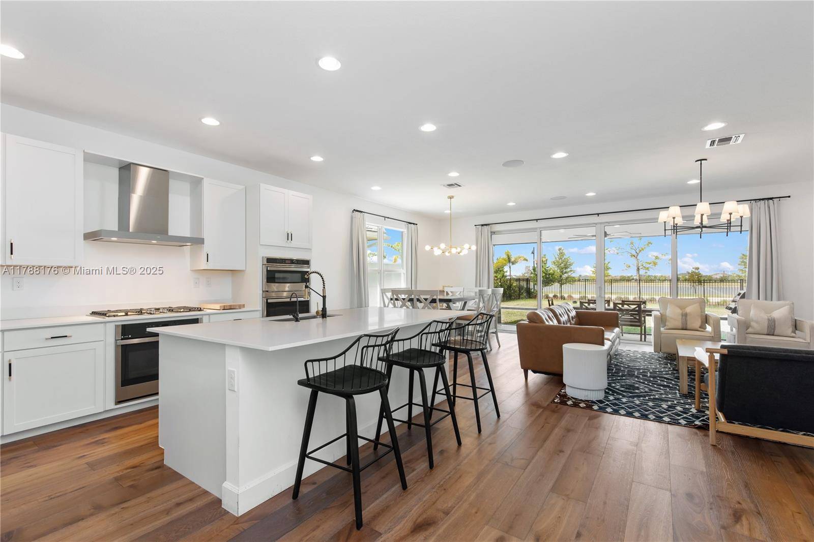 Gorgeous 4 3. 5 Single story lake front GL home features an inviting foyer leading into an open concept layout with glass impact sliders leading out to the covered lanai.