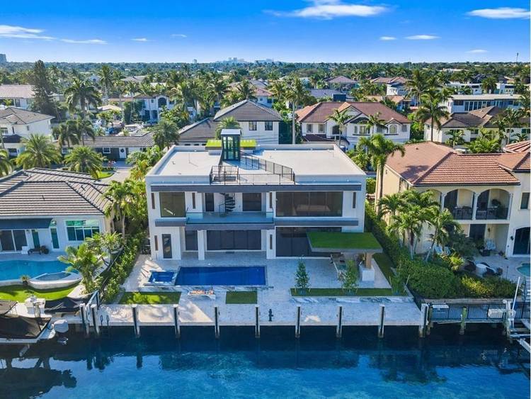This newly constructed waterfront modern home by Soverns Developers offers luxury living in a prime location with a newly constructed 80' seawall.