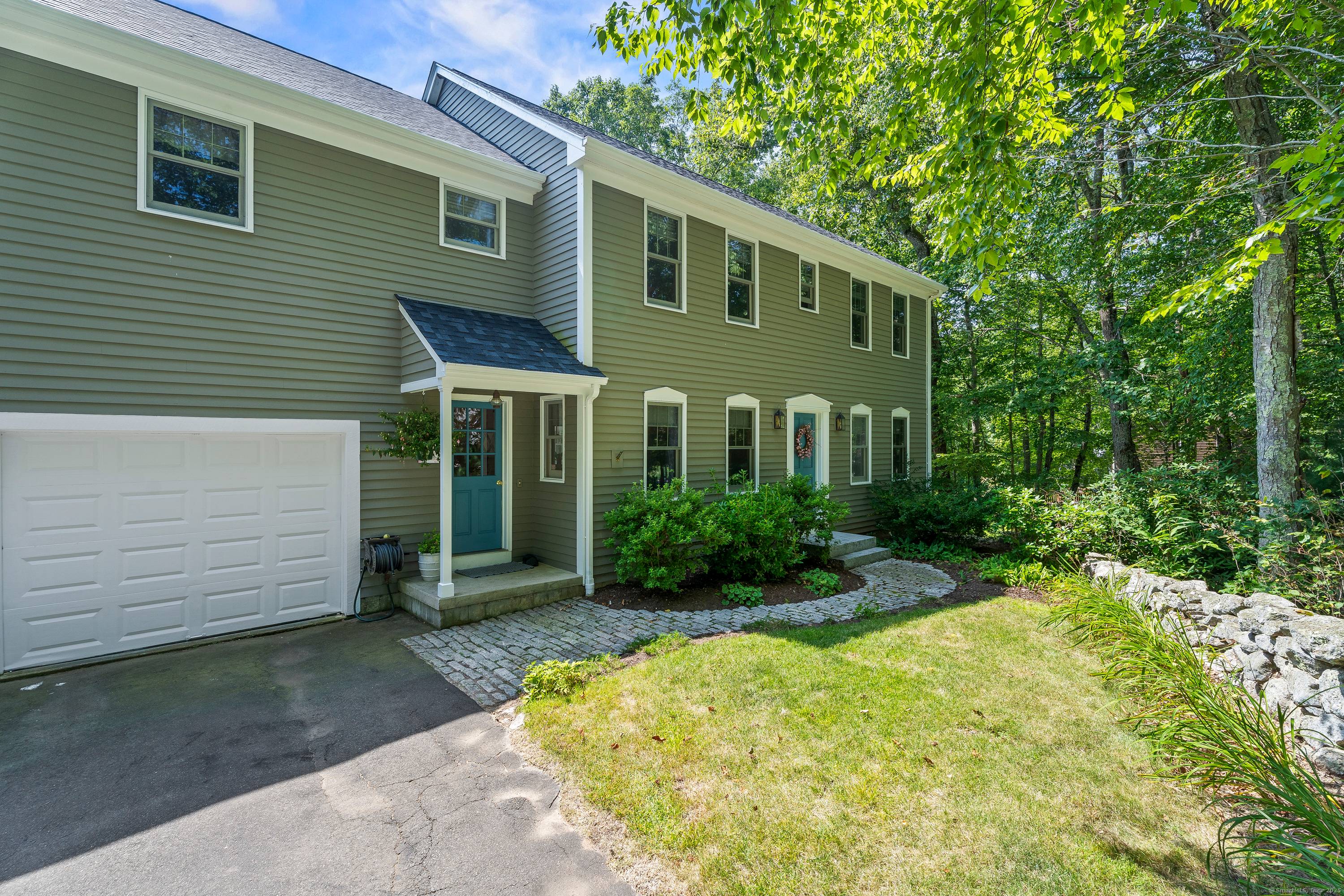 Nestled at the beginning of a quiet cul de sac and surrounded by mature trees and classic stone walls, this beautifully maintained 3 bedroom, 2.