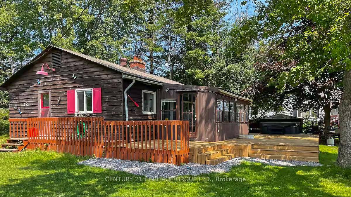Stunning 100 x 145 waterfront cottage on Pigeon Lake featuring a level lot with its own private boat launch.