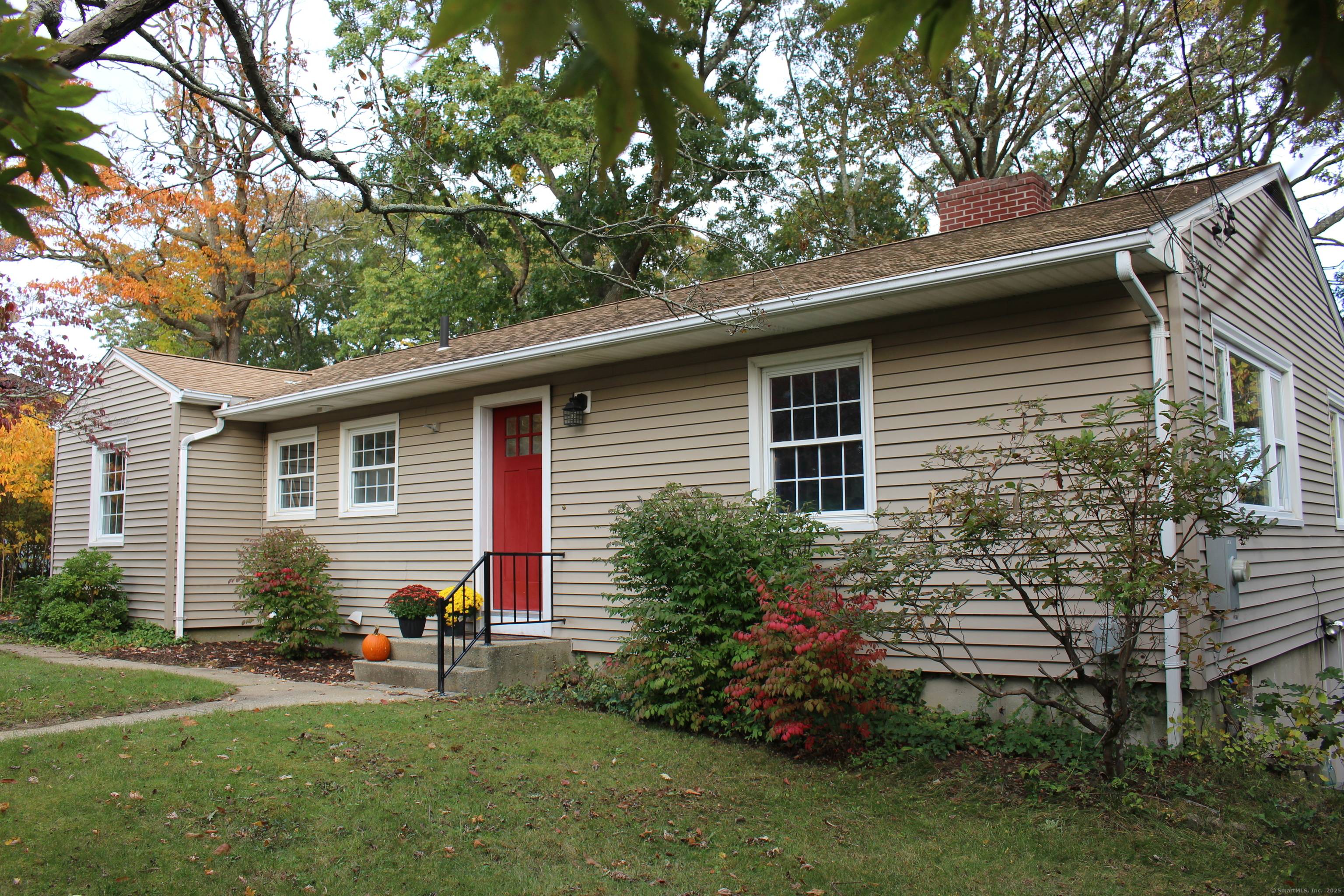 Welcome to 74 Twin Hill. A well maintained ranch style house features a single story design with a welcoming facade and neatly landscaped surroundings.