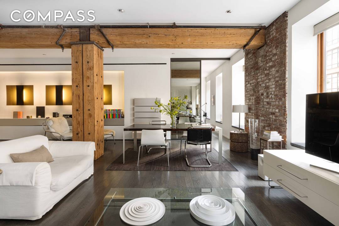 This stunning SoHo loft seamlessly blends industrial heritage with modern luxury, creating a diaphanous living space that epitomizes the essence of New York loft living.