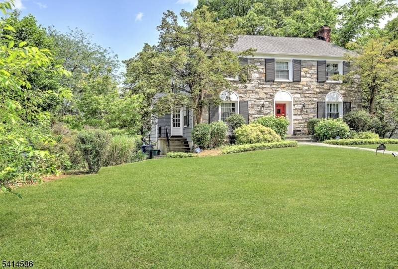 Welcome to this magnificent, historic stone front Center Hall Colonial, a true gem that blends timeless charm with modern comfort.