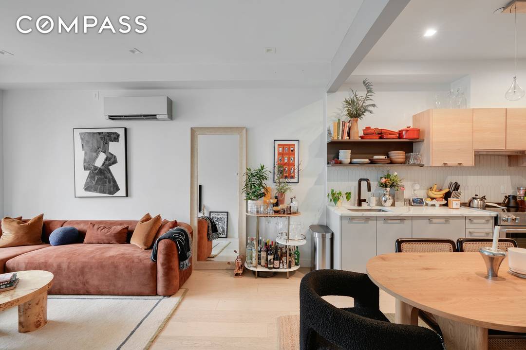 Perched atop a boutique building, this sun filled residence boasts northeastern exposure and wide plank Nordic White Oak flooring throughout.