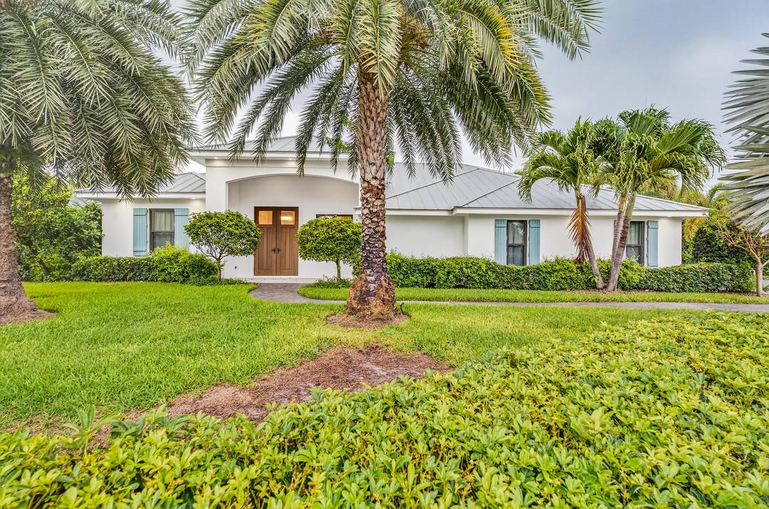 Poised upon a spacious. 52 acre cul de sac lot east of A1A, this meticulously renovated home is just a short walk to a serene beach with private deeded access.
