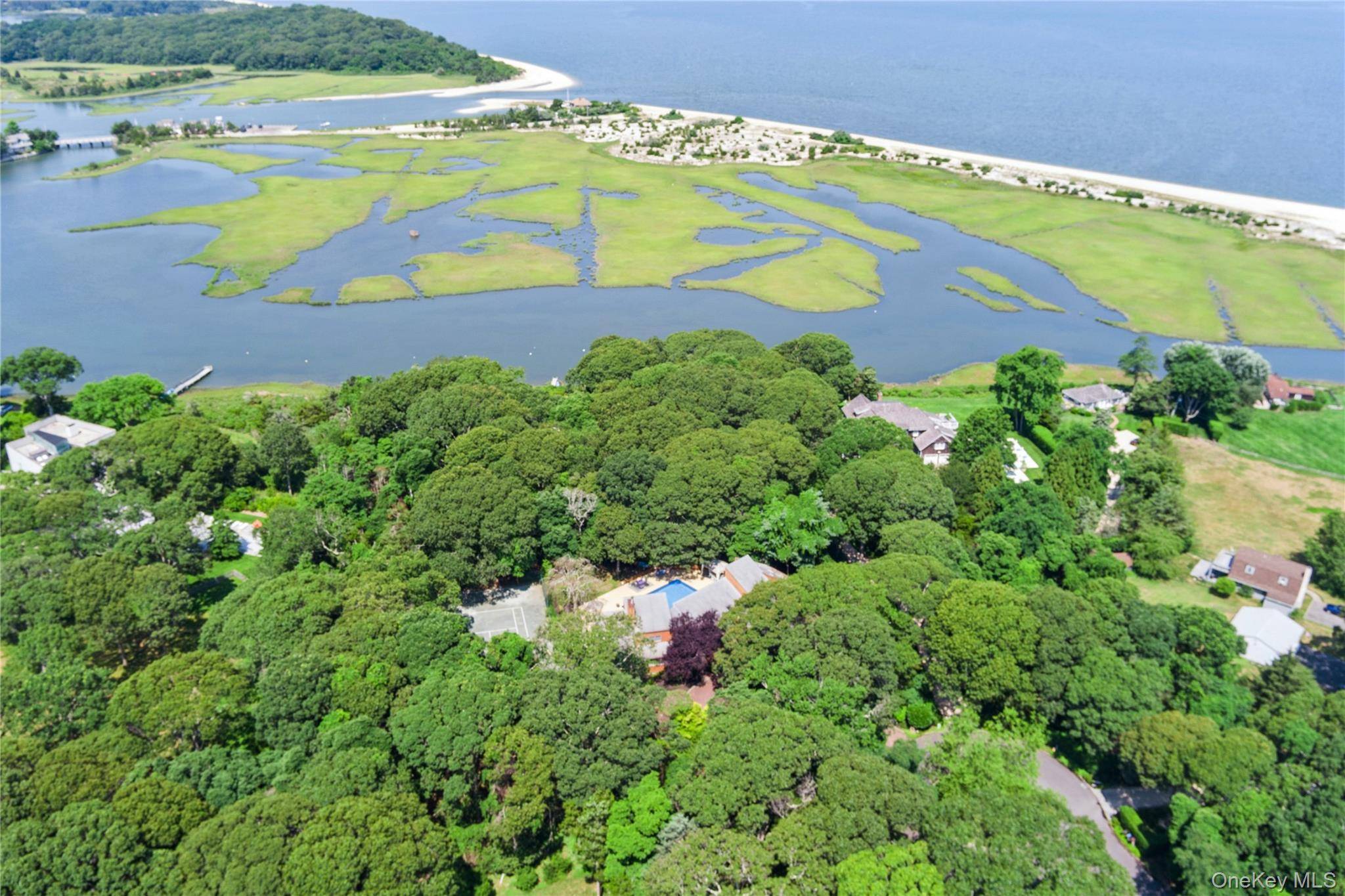 Tucked away on 1. 4 acres of lush, landscaped grounds, this bright contemporary residence offers the ultimate Hamptons lifestyle minutes from scenic bay beaches and local farm stands.