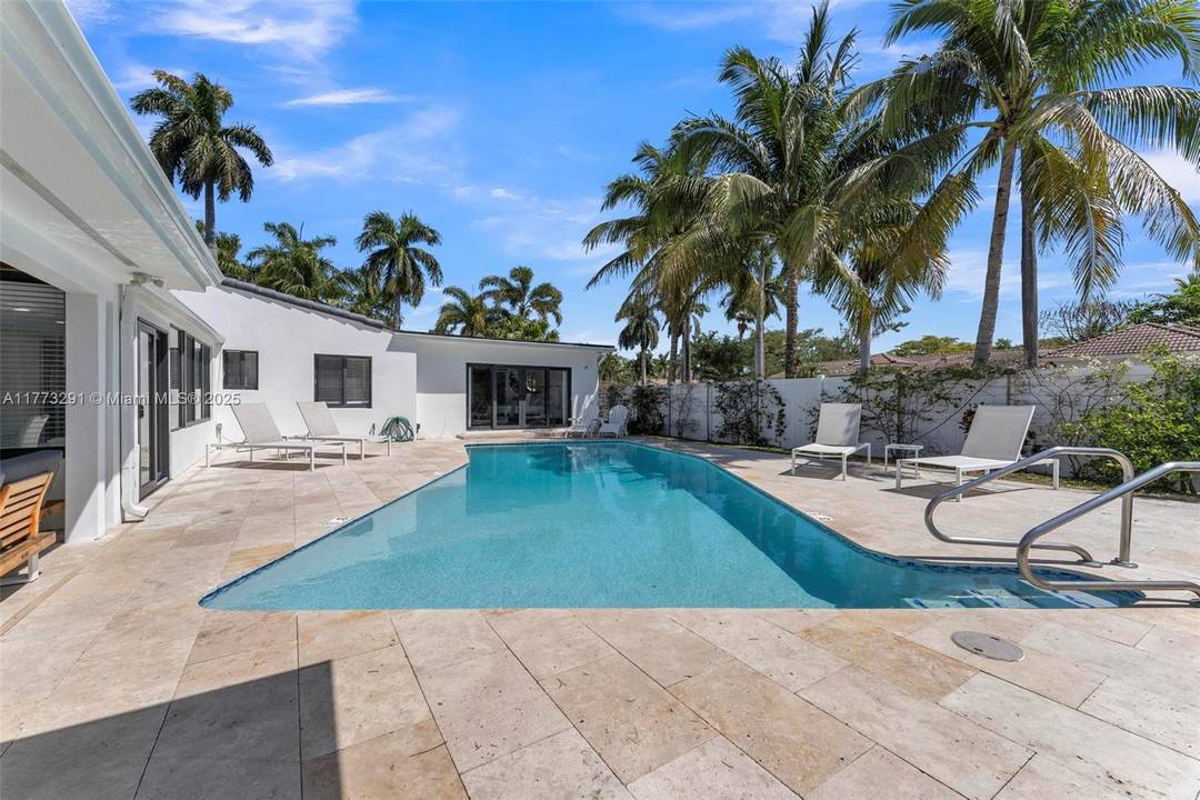 This beautifully updated pool house in Hollywood Lakes features three bedrooms and three full bathrooms, situated on an 8, 639 square foot corner lot.