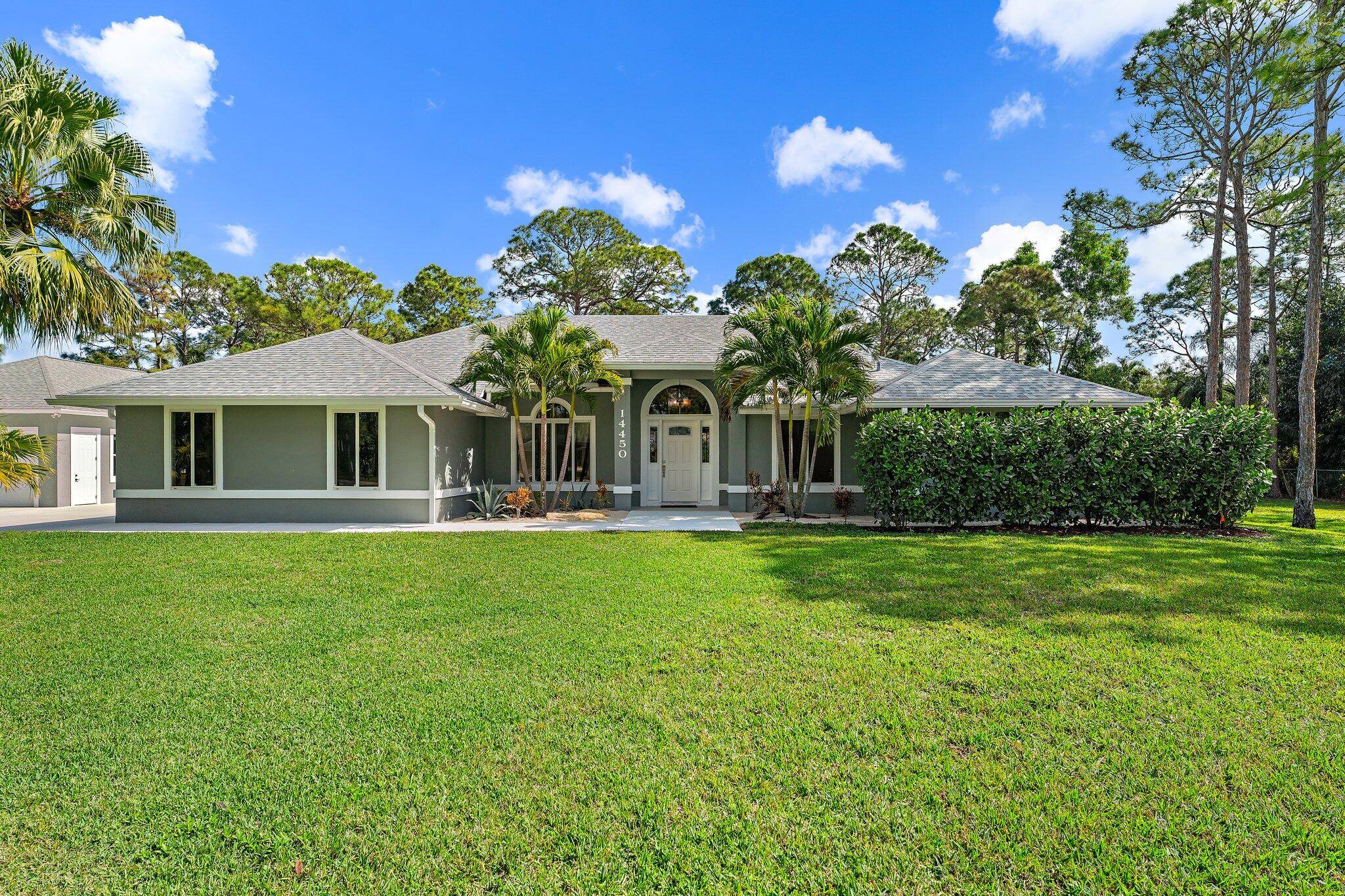 This 4 bedroom office den, 2 bathroom estate in Palm Beach Country Estates offers modern luxury on over an acre NO HOA !