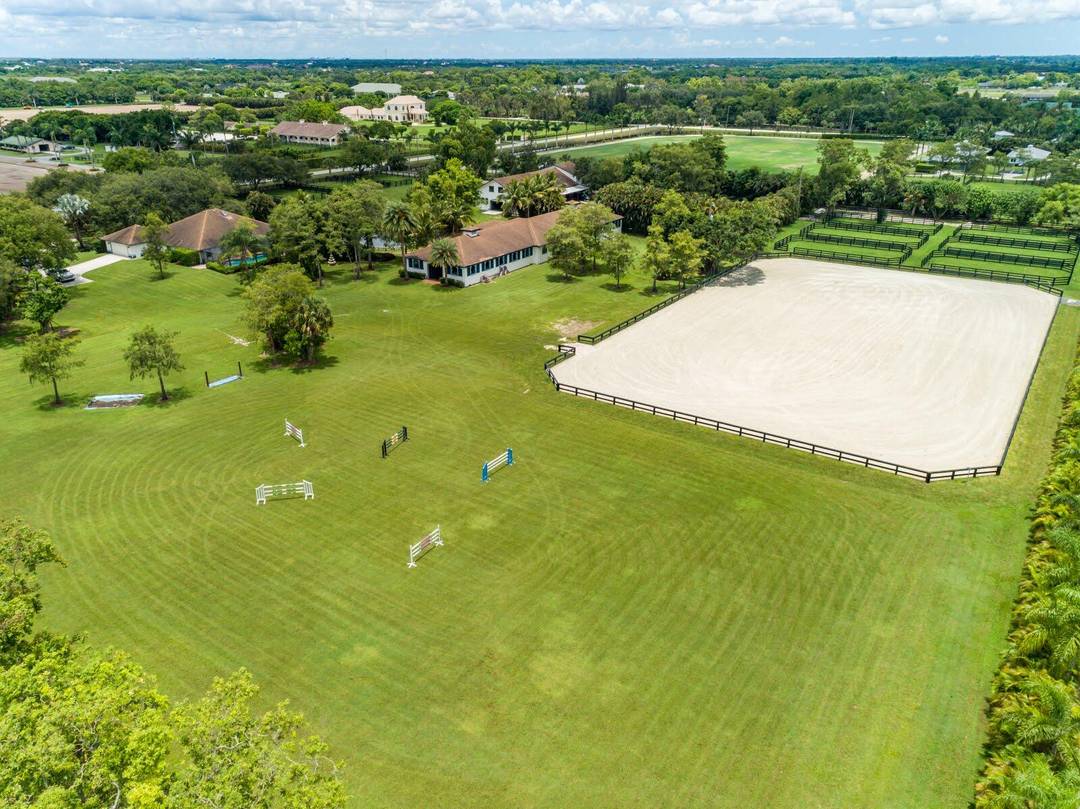 Enjoy the best of both worlds on this exceptional 10 acre equestrian property, ideally located just minutes from Global and WEF while offering the tranquility of Wellington's farm life.