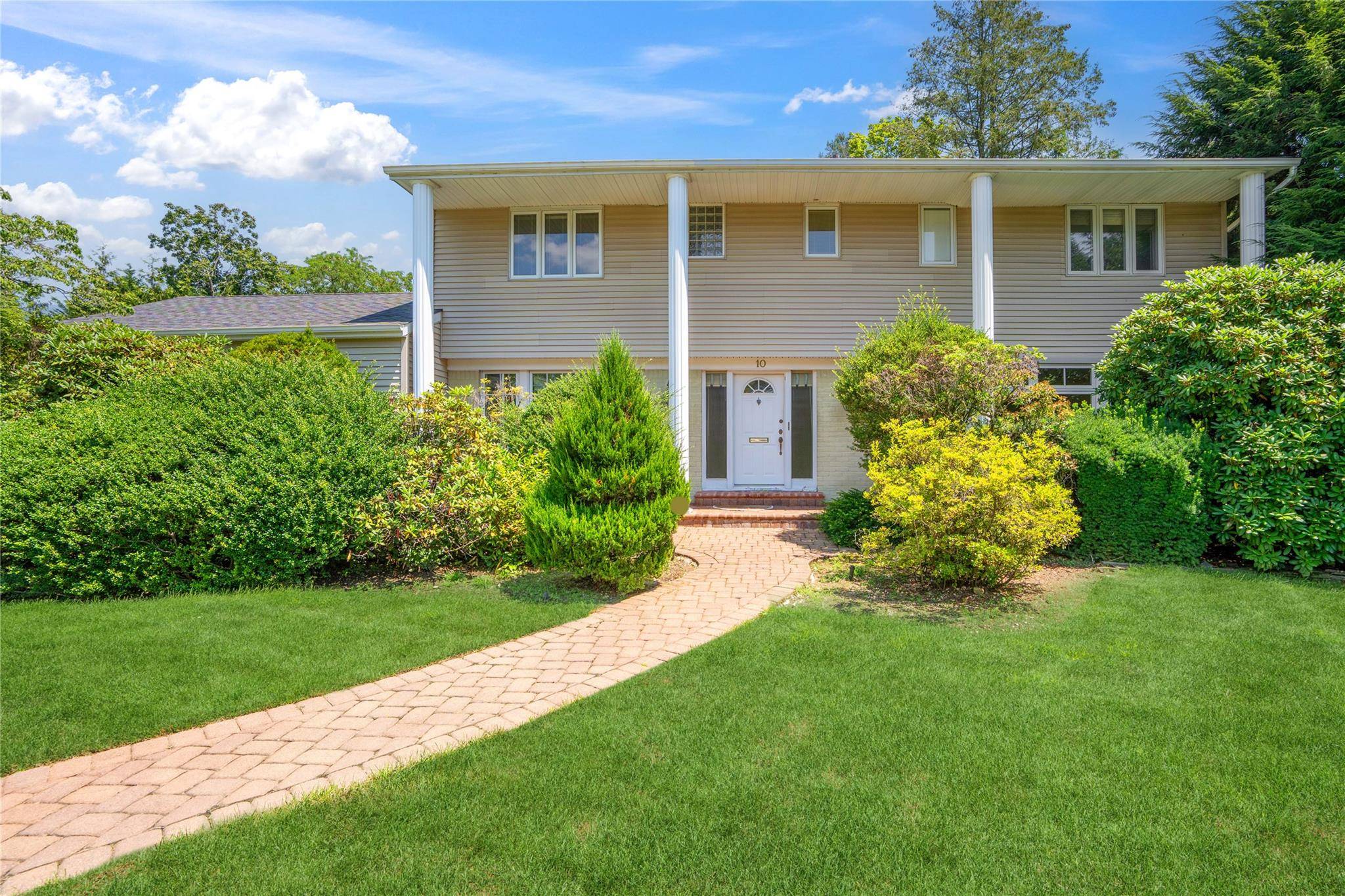 5 Bedroom, 2. 5 bath Colonial perfectly positioned mid block on a flat, 1 3 acre beautifully maintained property in the Roslyn School District.