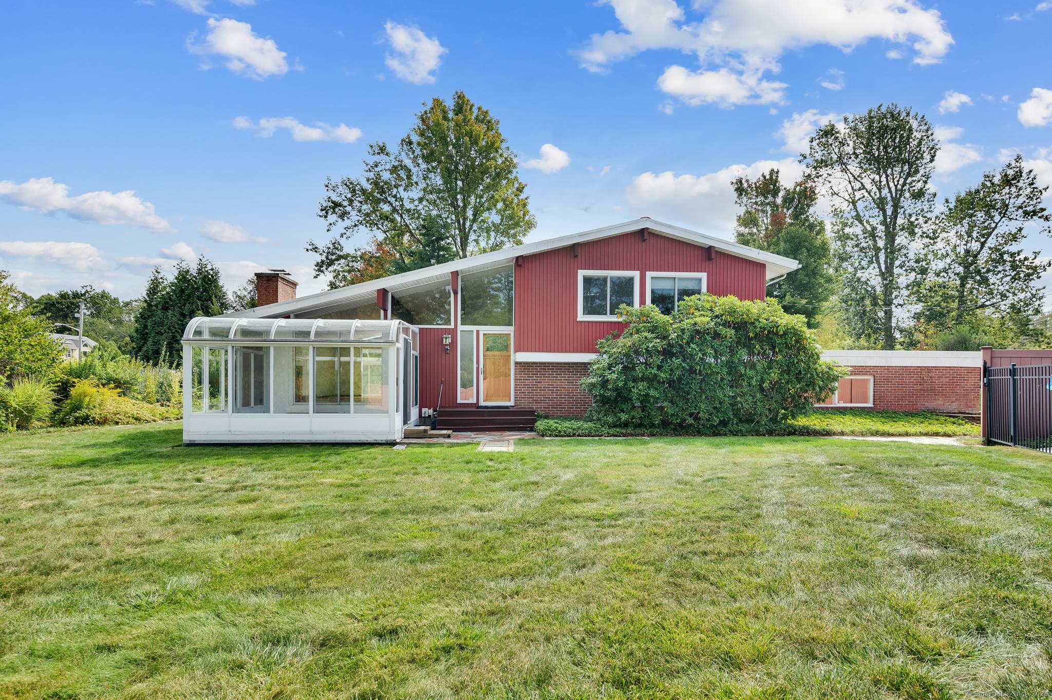 You will fall in love with this spacious midcentury modern home situated in a quiet neighborhood in Hamden.