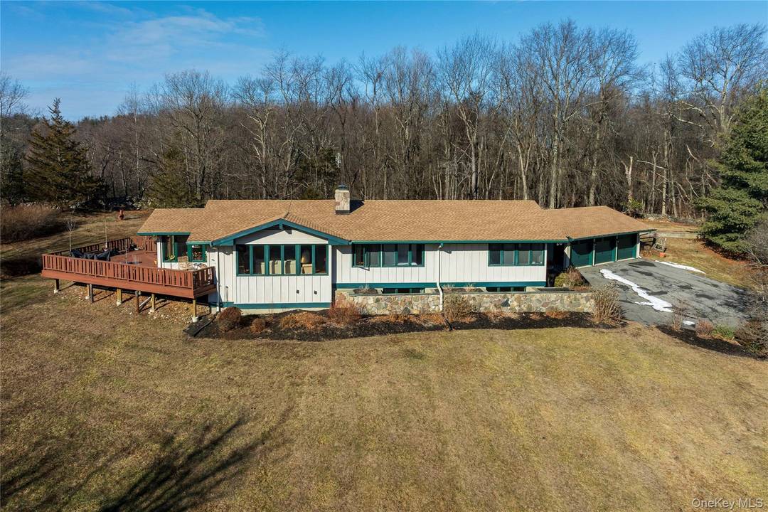 Privately set back from the road, this meticulously cared for home is peacefully perched into the hillside and surrounded by beauty.