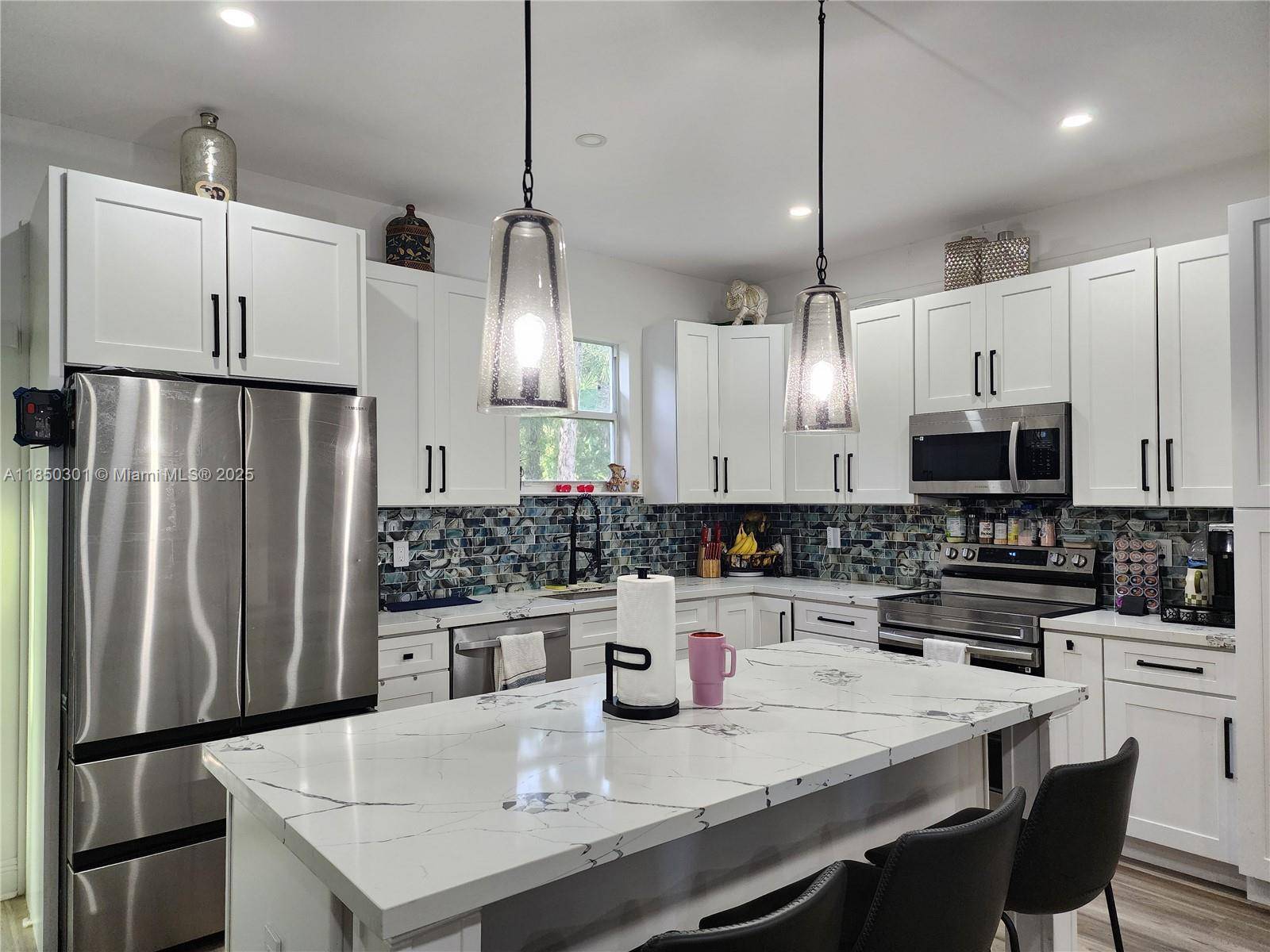 This immaculate, contemporary home located in the desirable Golden Gate Estates offers modern living on a spacious 2.