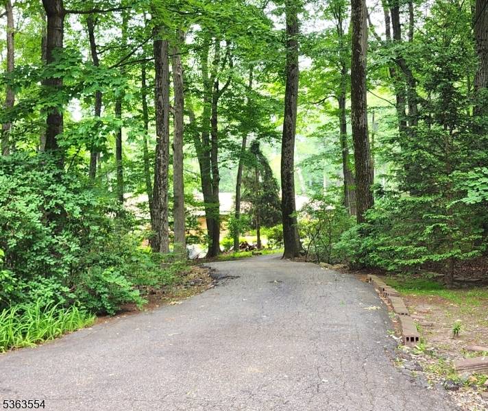 On a cul de sac In the coveted Stony Brook community of Kinnelon awaits your private paradise.