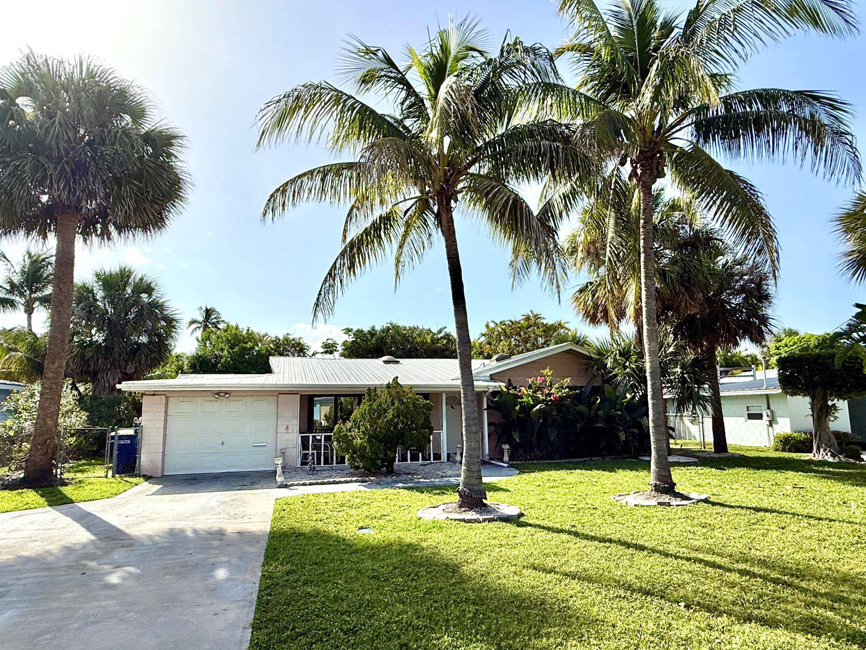 3 BEDROOM 2 BATH CBS HOME WITH NEWER METAL ROOF, ACCORDION SHUTTERS AND STEPS FROM THE BEACH AND INLET.