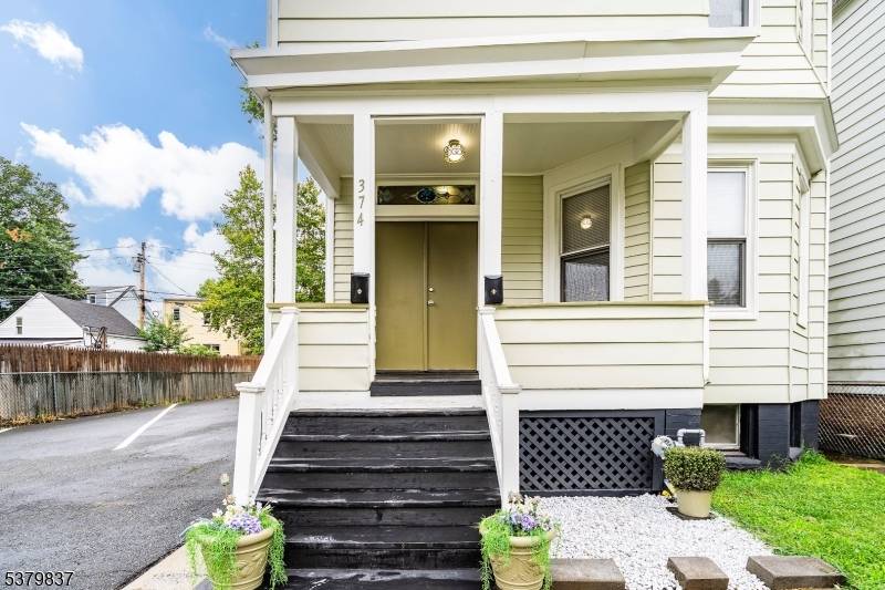 Renovated Two Family home nestled on a double lot in an attractive East Orange residential neighborhood !