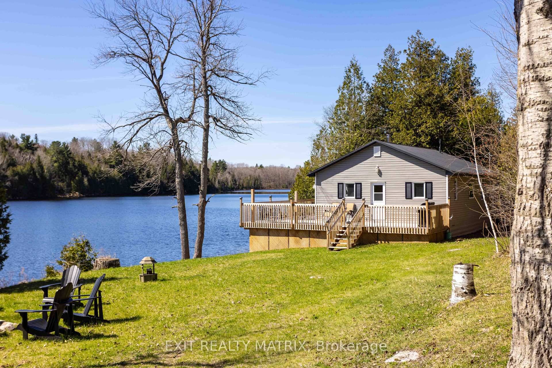 Tucked along the quiet shores of Cox's Lake, where the water gently laps at the earth and loons call across the still morning mist, sits a cottage that feels like ...