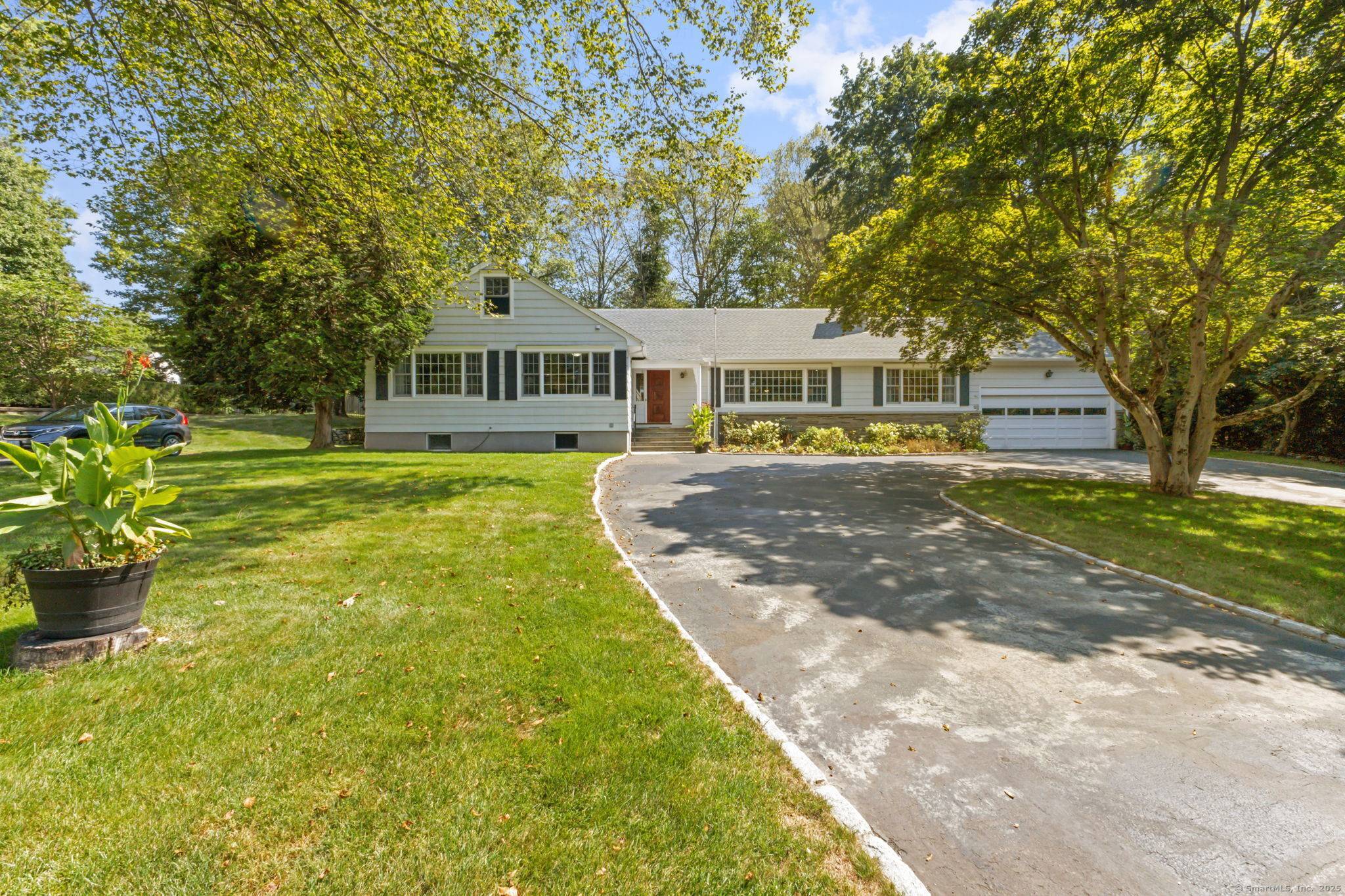 A quintessential New England Ranch set behind stone walls and a rounded driveway, this home welcomes you with timeless style and impressive scale.