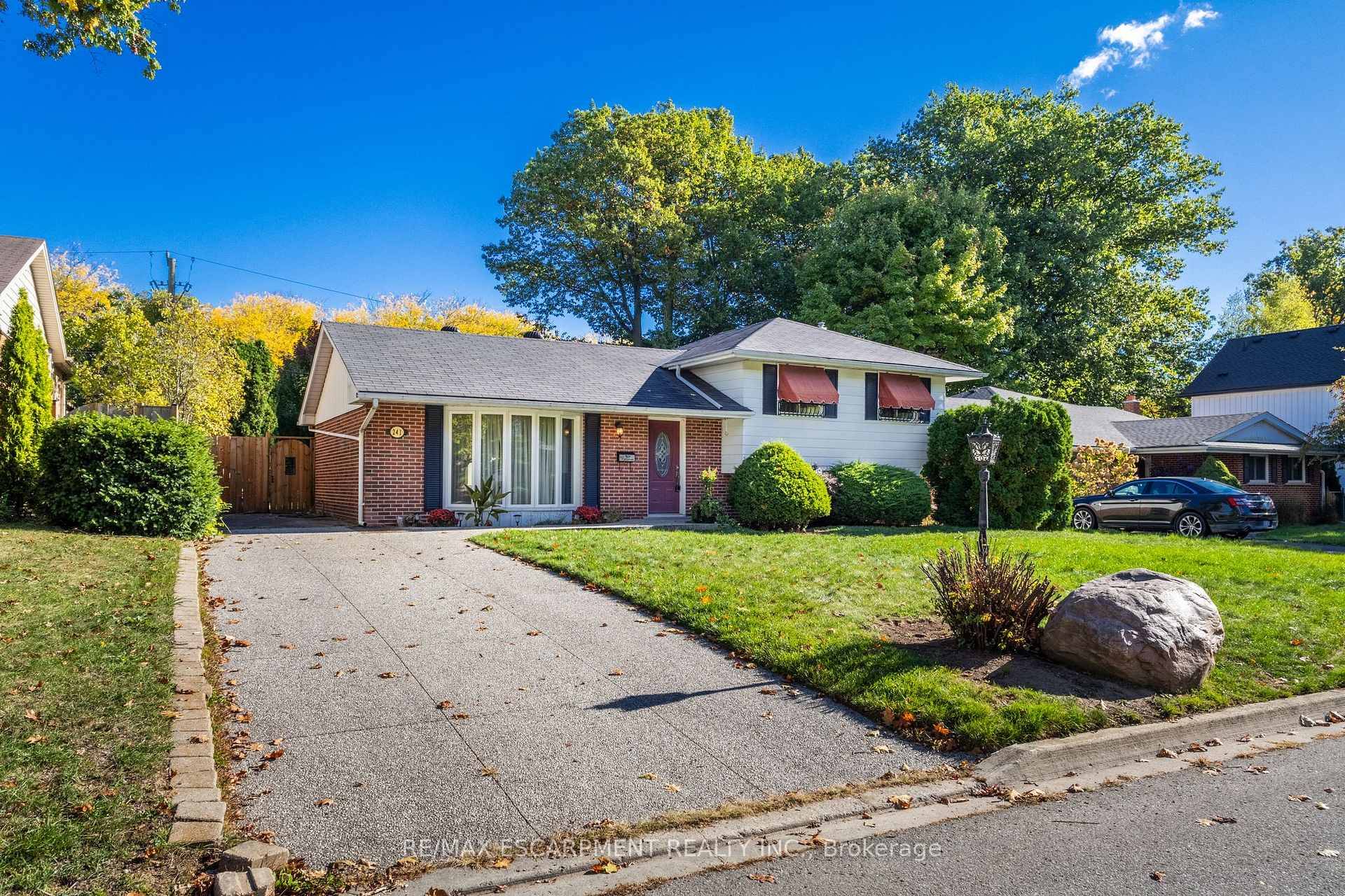 Welcome to this 3 level side split, detached home filled with light and the charm of mid century.