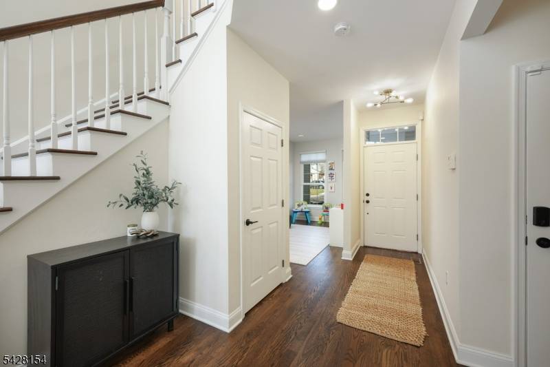 Step into light filled elegance in this beautifully maintained Martinsville townhome, where soaring 2 story ceilings and rich hardwood floors create an immediate sense of space and style.