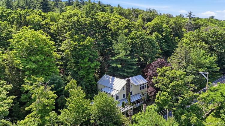 Tucked into a dramatic rock ridge with sweeping views of the Catskill Mountains, this renovated farmhouse invites you to slow down and savor country living at its finest.