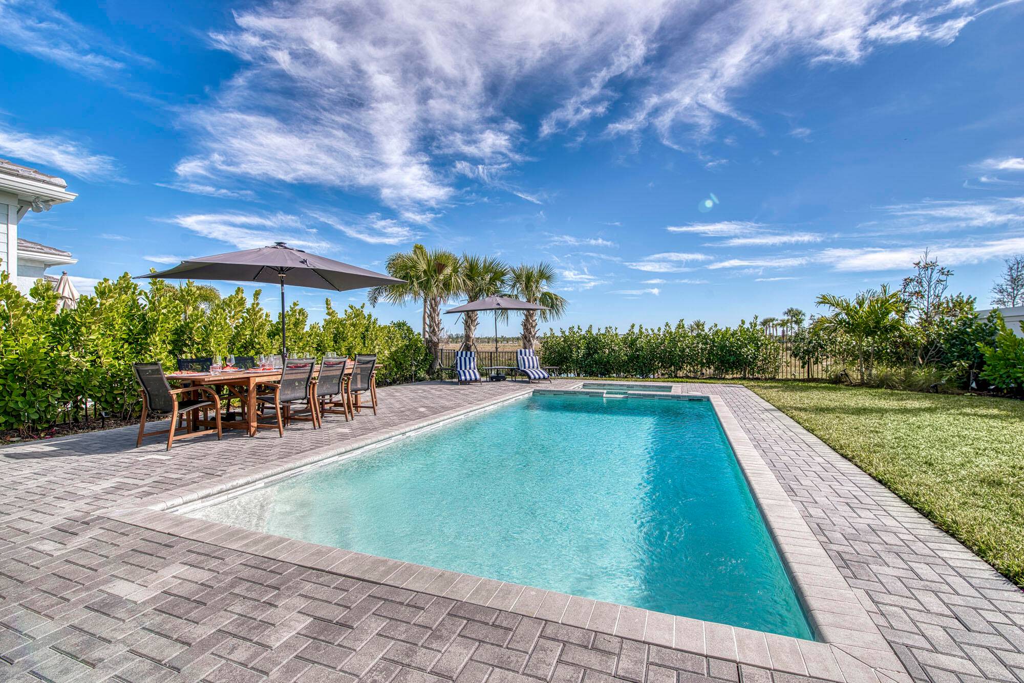 Modern Pool Home on quiet cul de sac with Designer elements in Avenir.