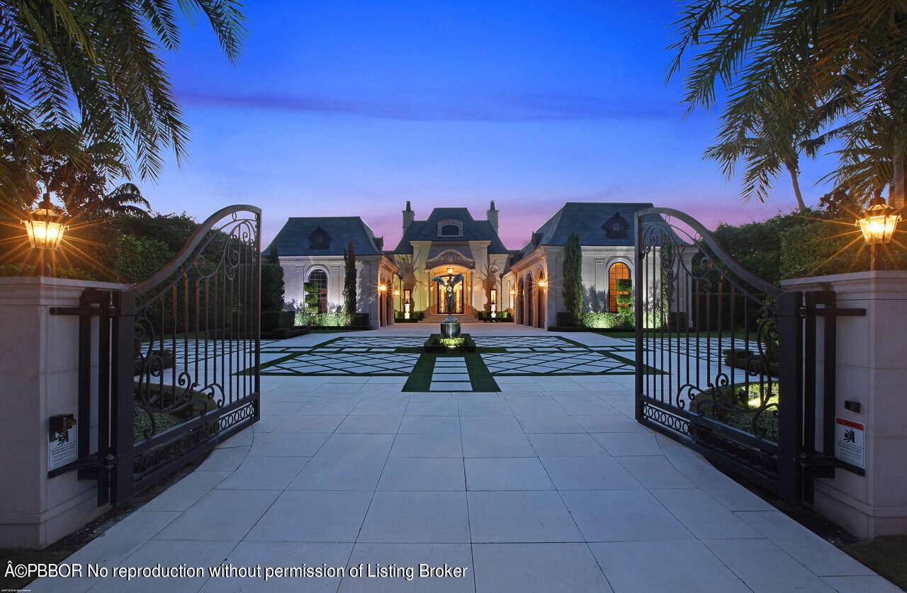 Modern elegance meets traditional style throughout in this stunning French Chateau inspired waterfront home in the prestigious Admiral Cove.