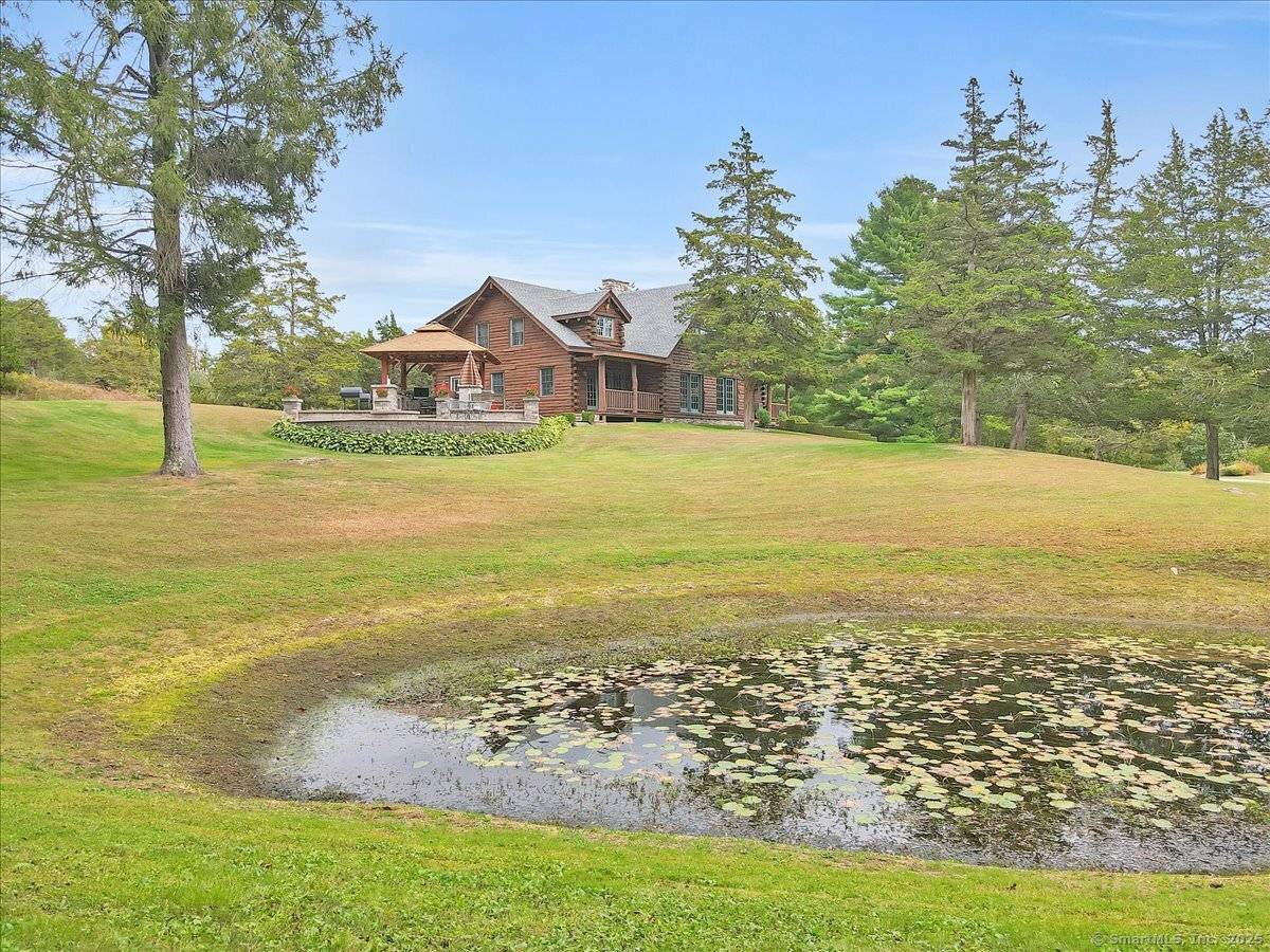 Rustic Luxury in Connecticut's Quiet Corner Nestled in the hills, this stunning custom log home blends rustic charm with modern comforts.