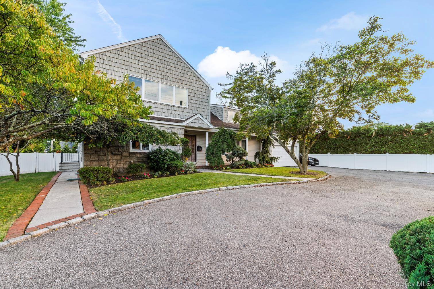 Welcome to this warm and inviting 6 bedroom, 4 bath home in the heart of Hewlett Harbor.