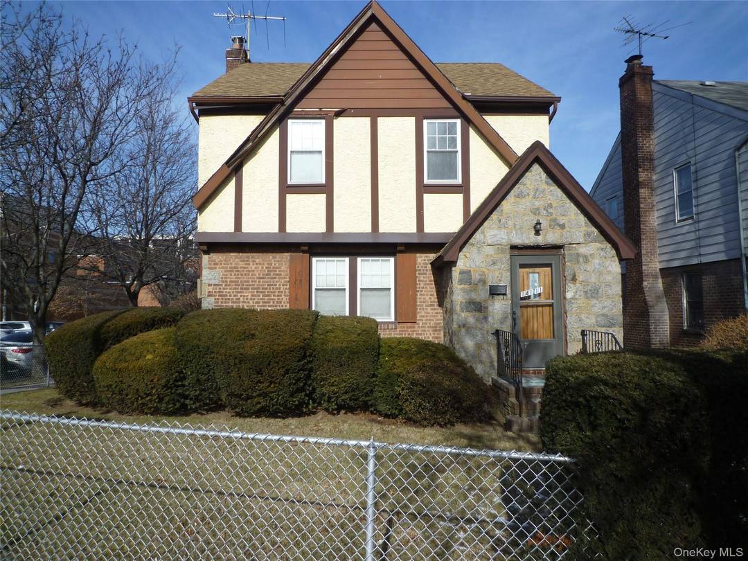 Corner property with a private driveway to a 2 car garage.