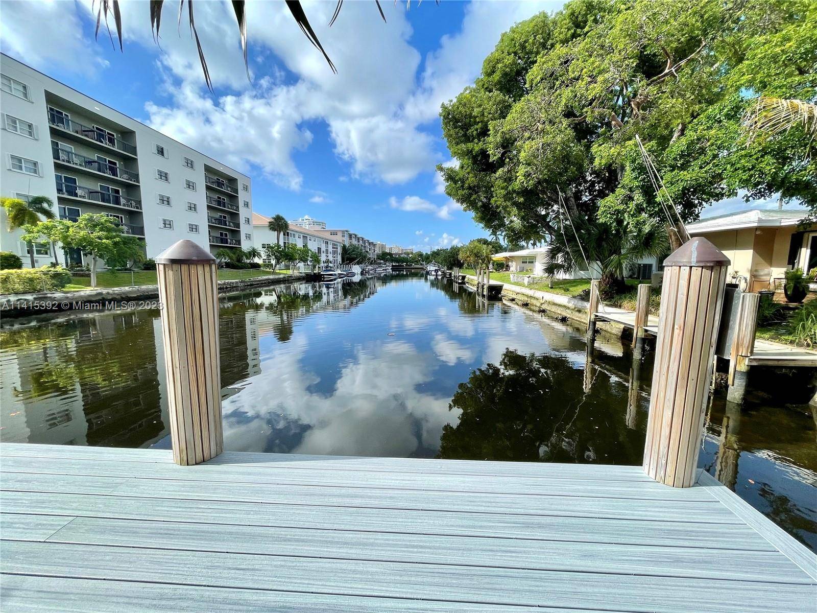 A BEACH LOVERS DREAM ! RARE AND HARD TO FIND GROUND LEVEL, WITH PRIVATE BEACH ACCESS AND A VIEW OF THE CANAL, AND BOAT DOCK.