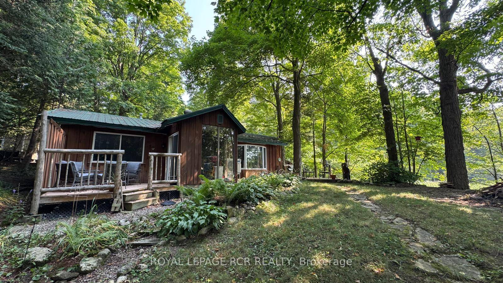 Tucked away in the coveted Roman Lake community, this rustic yet refined bungalow offers the ultimate private escape.