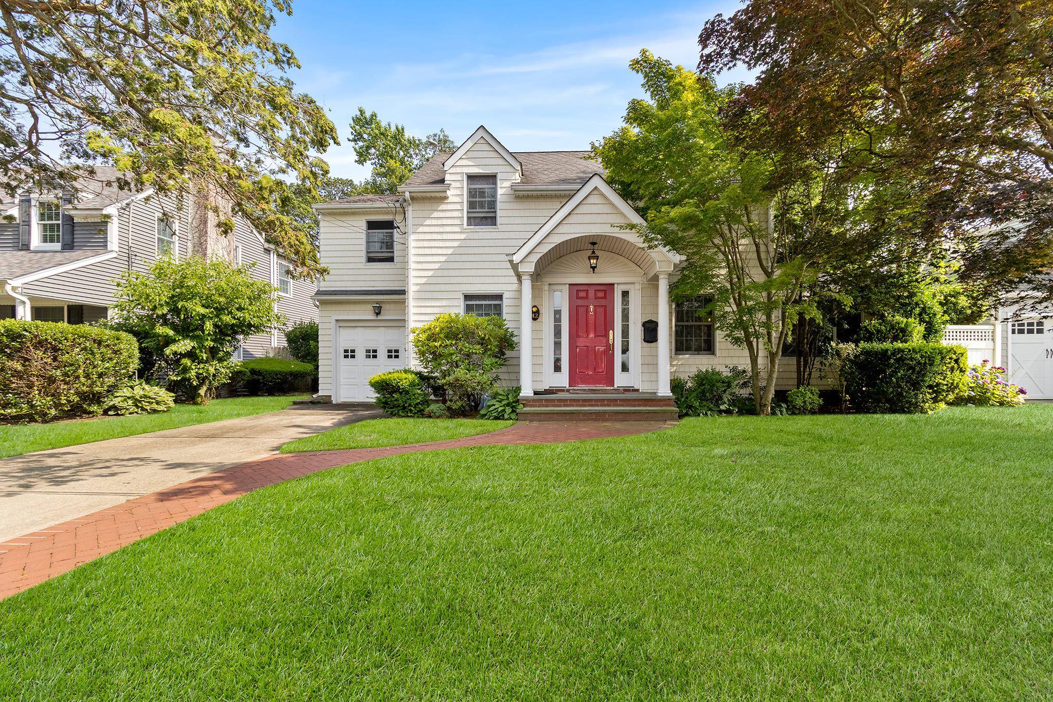 Welcome to 42 E Webster St an expanded Colonial nestled in the heart of Merrick Woods with classic curb appeal, a charming façade, and beautifully landscaped front yard.