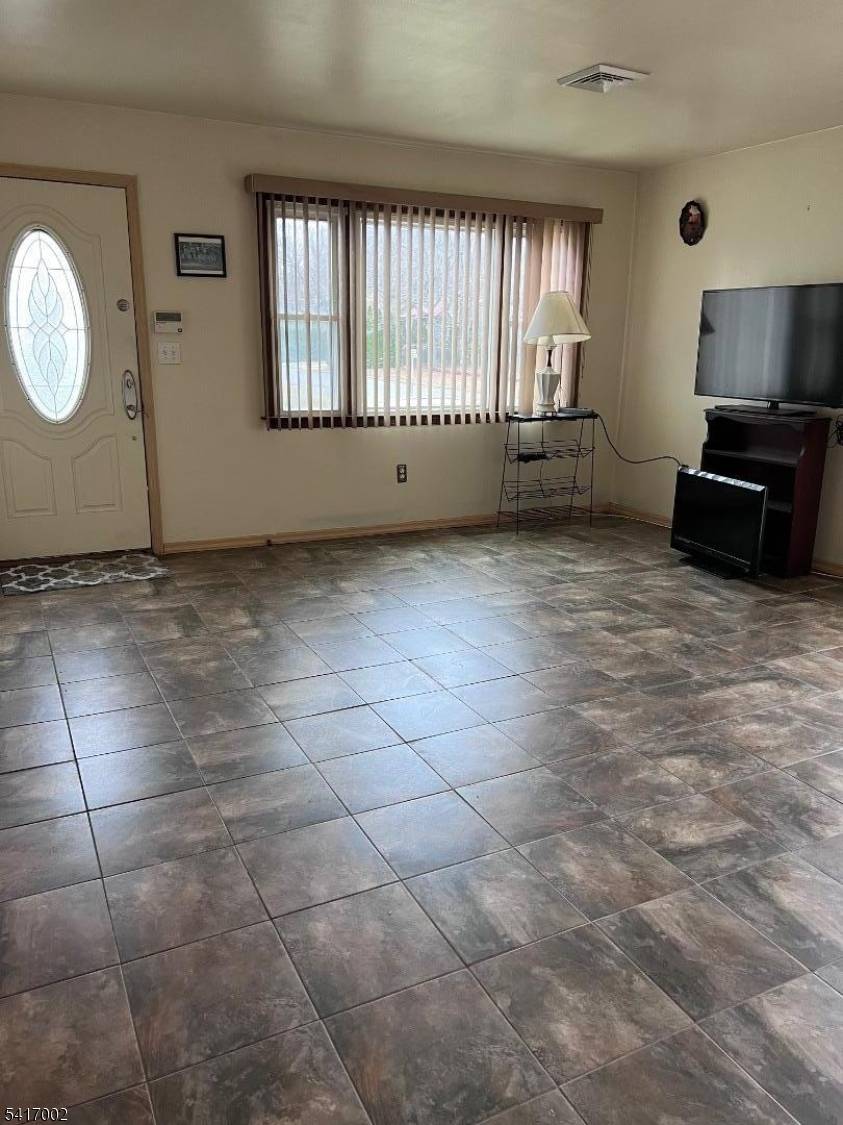 Well maintained 3 bedroom, 1 bath ranch featuring a spacious living room with sliding doors that open to a large deck perfect for entertaining.