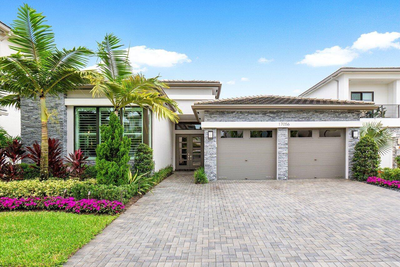 Introducing this exquisite contemporary Sevilla model, nestled within the prestigious Boca Bridges, where luxury living meets chic elegance.