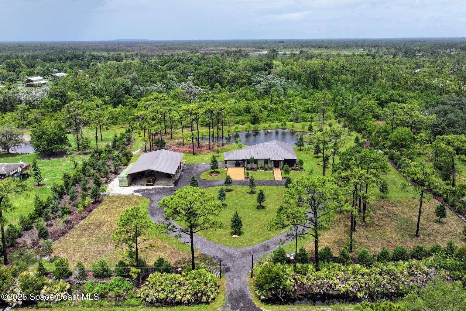 CBS 2BR 2BA custom home on 5 acres with a peaceful pond, private island, waterfall, and land bridges.