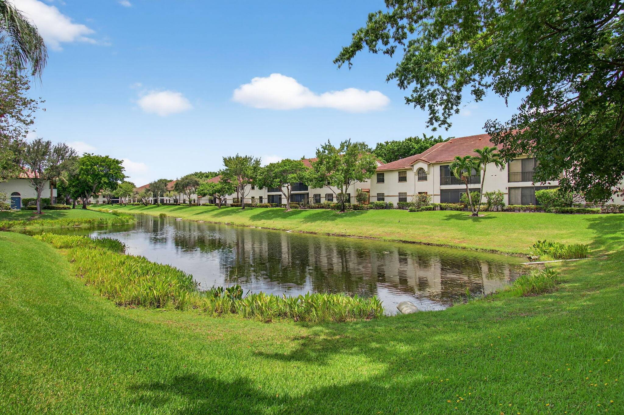EXPERIENCE THIS STUNNINGLY AFFORDABLE WATER VIEW 3BR 2BA condo with elevator access in the all ages gated community of resort style Platina in Boynton Beach !