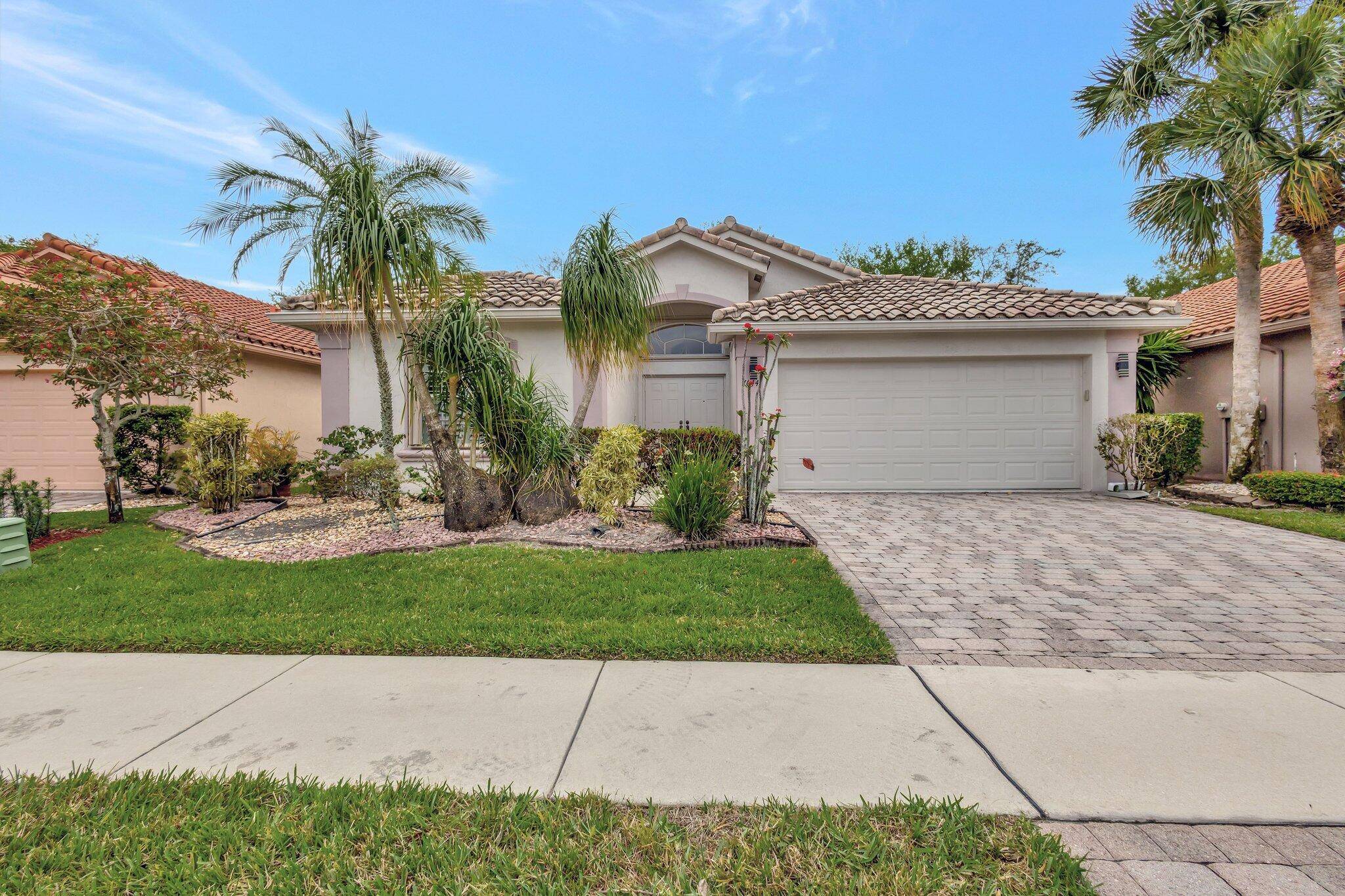 This CUSTOM ESTE model boasts an open floor plan with diagonal ceramic tile throughout and a bright Southern exposure, featuring French doors and plantation shutters.