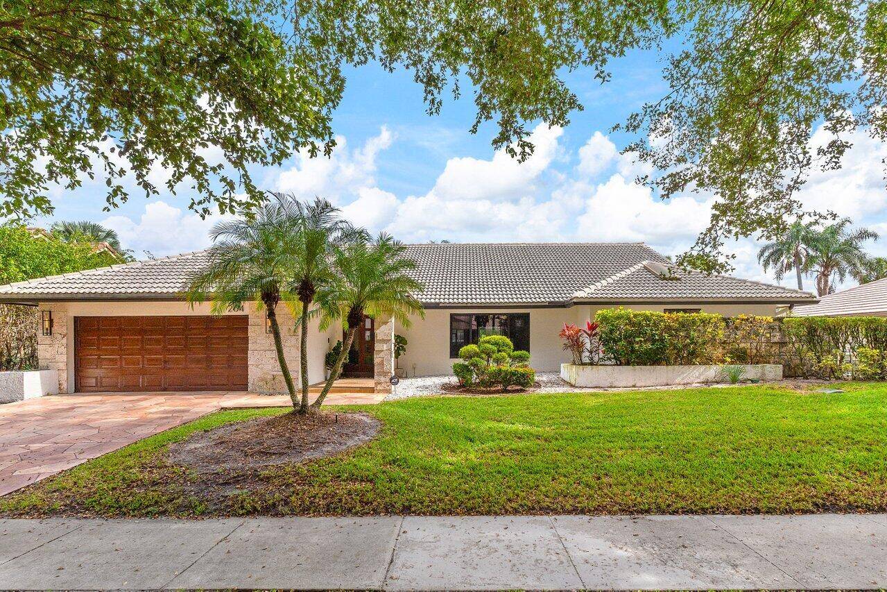 Welcome to this exquisitely renovated and designed 4 bedroom, 3 bath home situated on the 15th Fairway of the prestigious Deer Creek Golf Club.