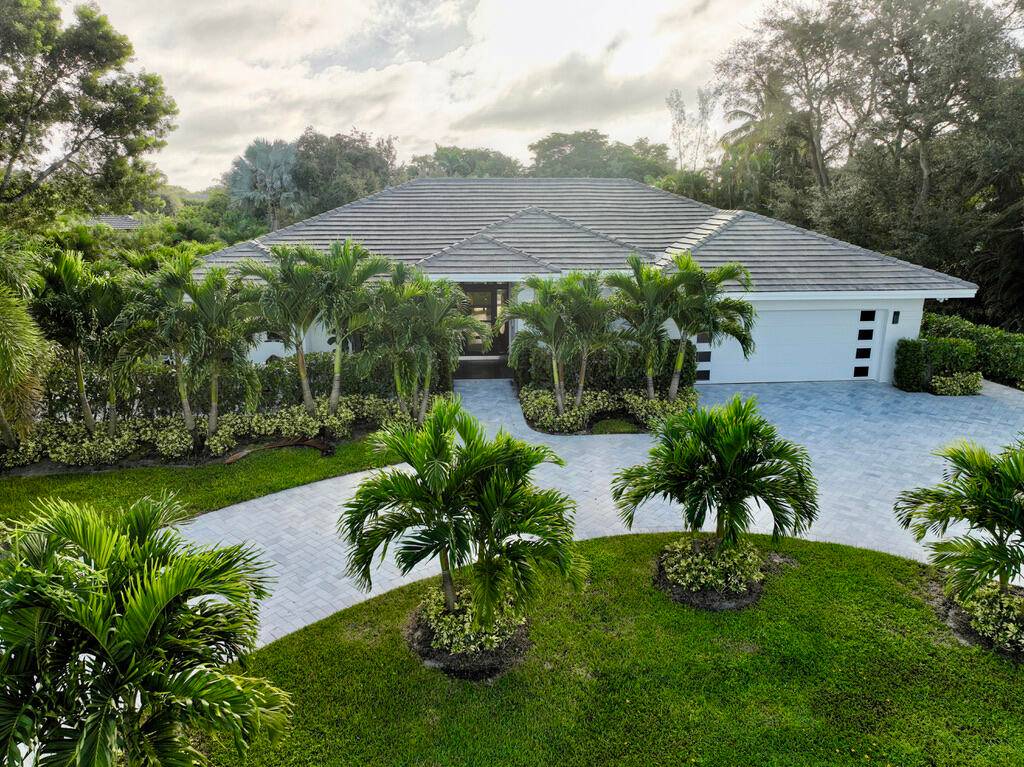 Stunning 3BR 3BA home on a private 1 acre lot nestled behind the gates of the exclusive Delray Lakes Estates.