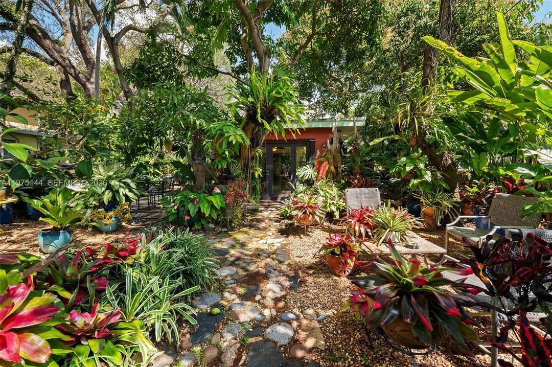 Superbly located in sought after South Coconut Grove, this residence is nestled within a private tropical oasis featuring a lush and impressive collection of mature plants.