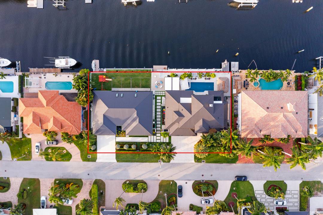 A rare waterfront compound offering two designer renovated homes with 180' of deepwater in Tropic Isle.