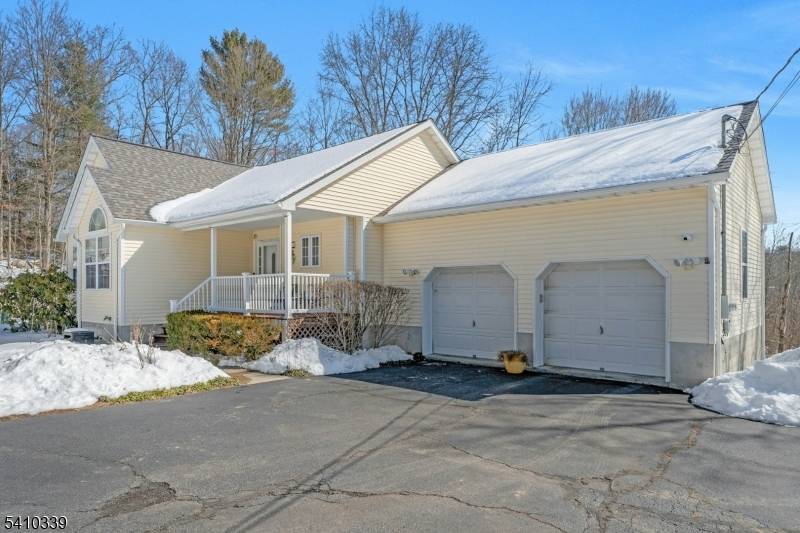 Charming and beautifully maintained, this inviting ranch is set well back from the road on over 2.