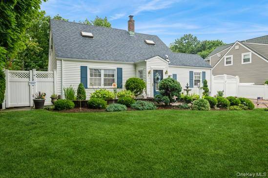 Beautiful Curb Appeal Cape in the Heart of Levittown which Boasts Paved Entryway and Gorgeous Landscaping.