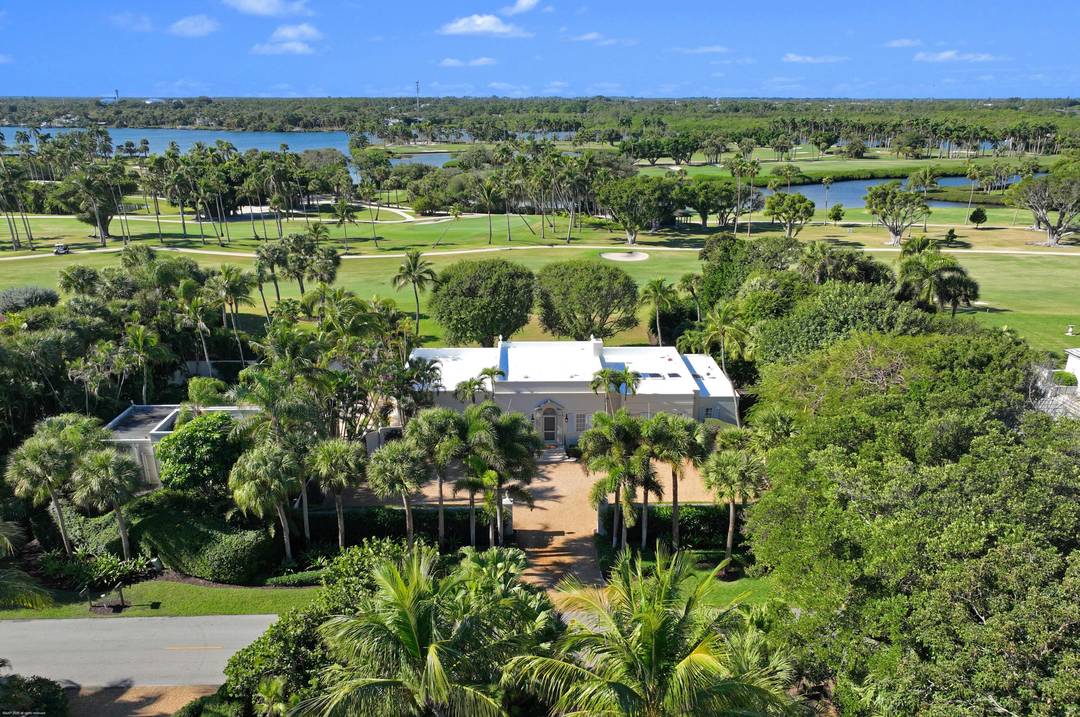 Nestled on prestigious Jupiter Island, this iconic residence designed by renowned architect F.